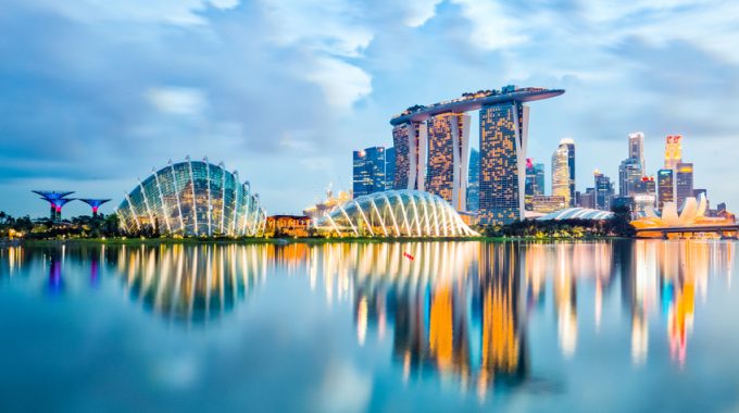 Singapore City, Singapore - July 17, 2015: Marina Bay Is A Bay Near Central Area In The Southern Part Of Singapore, And Lies To The East Of The Downtown Core. The Area Surrounding The Bay Itself, Also Called Marina Bay